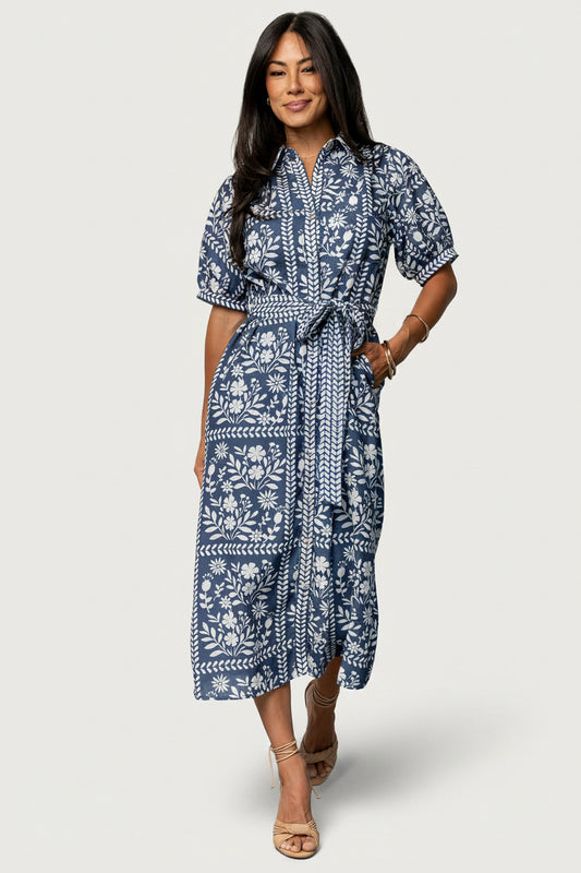 Front view of Karla midi dress in deep slate with off-white floral print, collared neckline, button-down front, and adjustable waist sash.