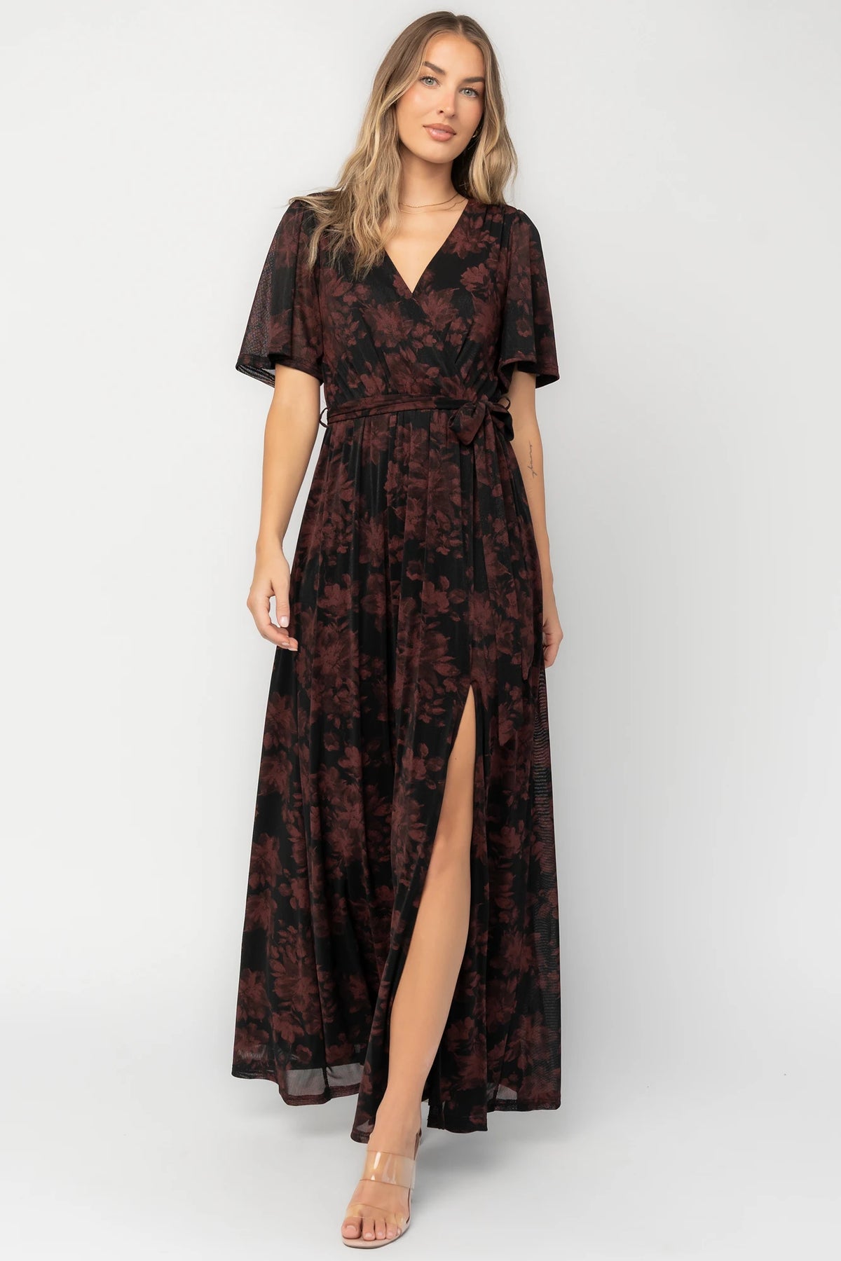 Reverie Maxi Dress in Black + Burgundy with floral print, surplice V-neck, sash waist, long sleeves, and side leg slit.
