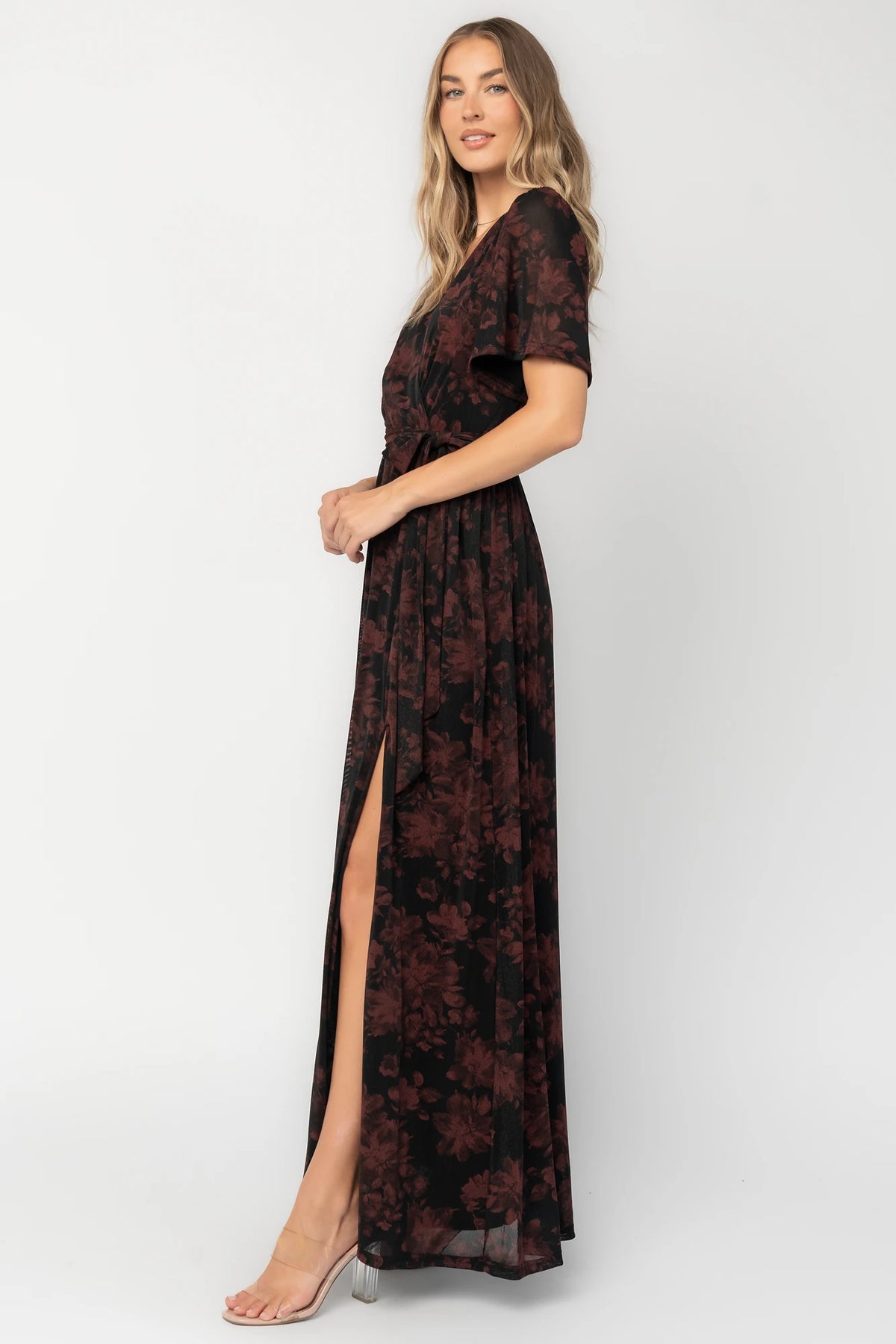 Reverie Maxi Dress in Black + Burgundy with floral print, surplice V-neck, sash waist, long sleeves, and side leg slit.