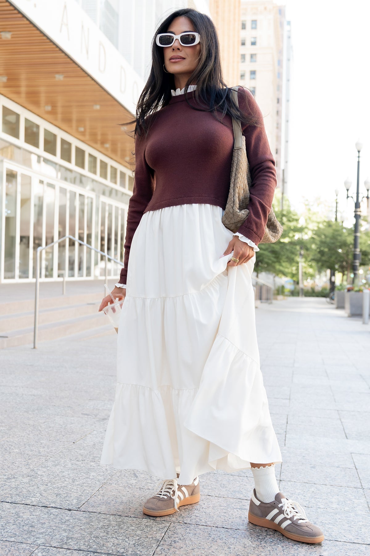 Front view of model wearing the Sophie Sweater Dress in mahogany and ivory, showing ruffled neckline, sweater-knit bodice and tiered maxi skirt.
