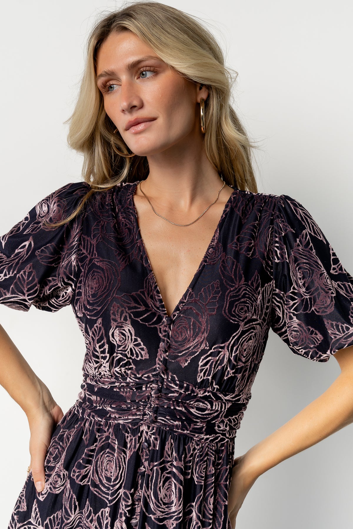 Close-up of embossed velvet pattern on Dahlia dress, highlighting textured lilac floral roses and subtle sheen of the fabric.