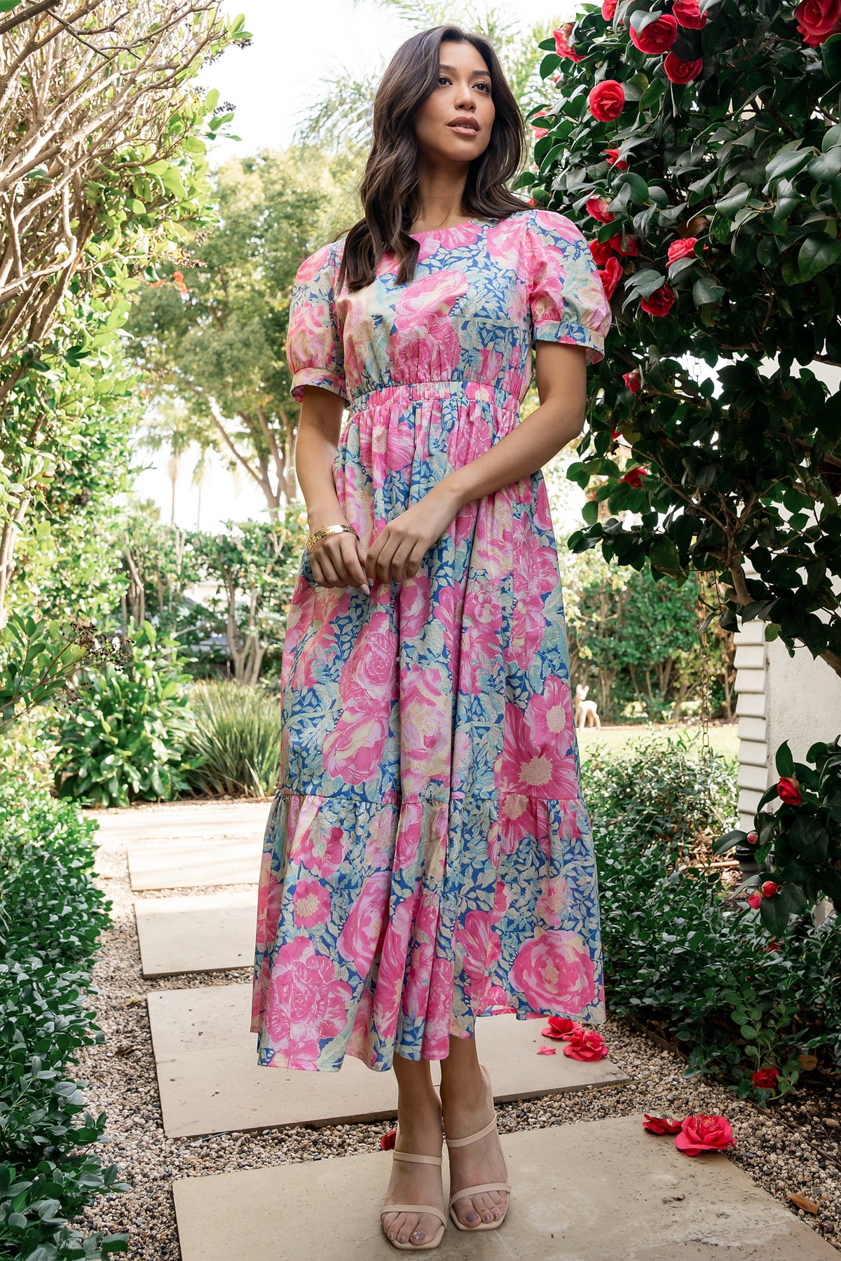 Three-quarter view of the blue and pink floral midi dress highlighting sleeve length, elastic waist, and gentle skirt drape.