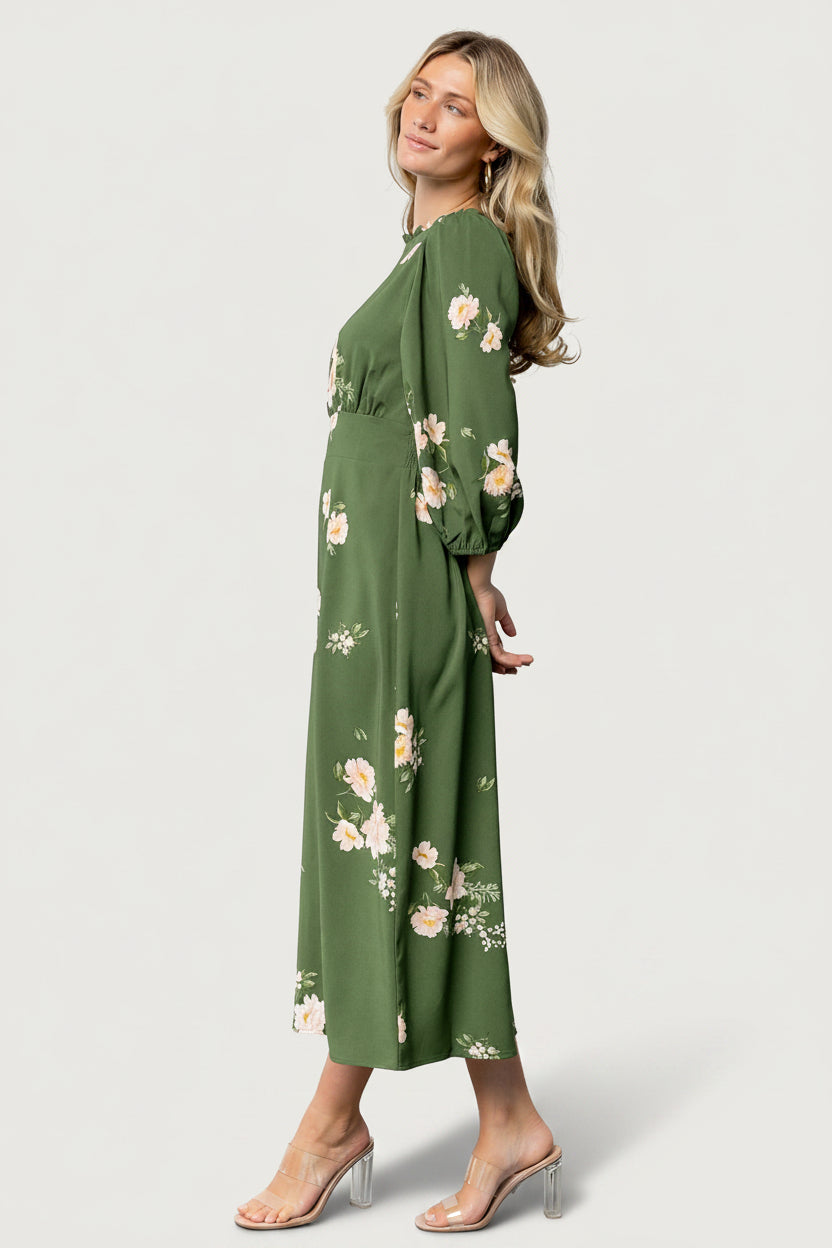 Styled shot of the Karalie Maxi Dress in green floral, showing overall fit, print scale, and how the smocked waist shapes the silhouette.