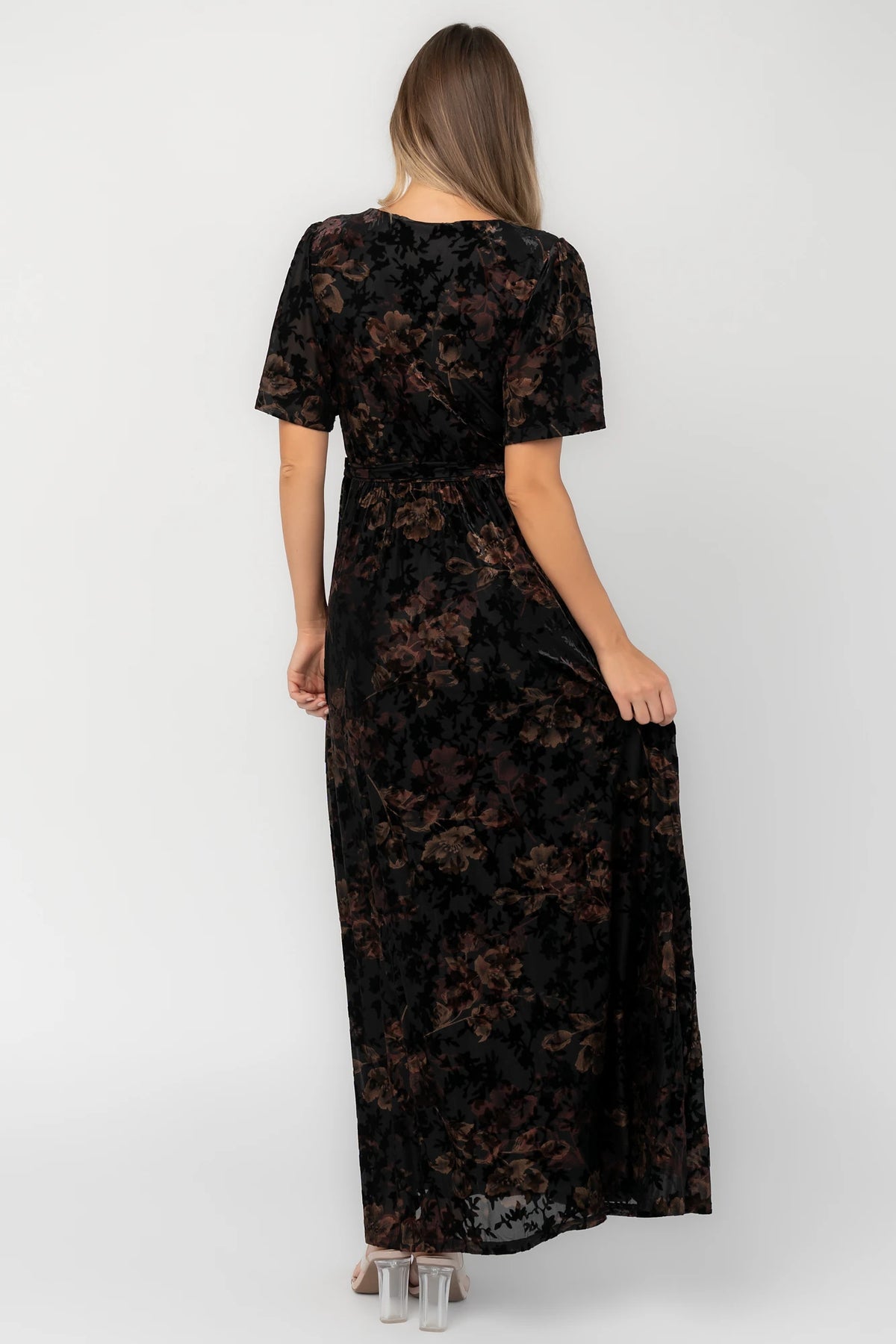 Bronze and black burnout velvet maxi dress with a surplice V-neckline, short flutter sleeves, elastic waist with a removable tie, and a flowing skirt with a side slit.