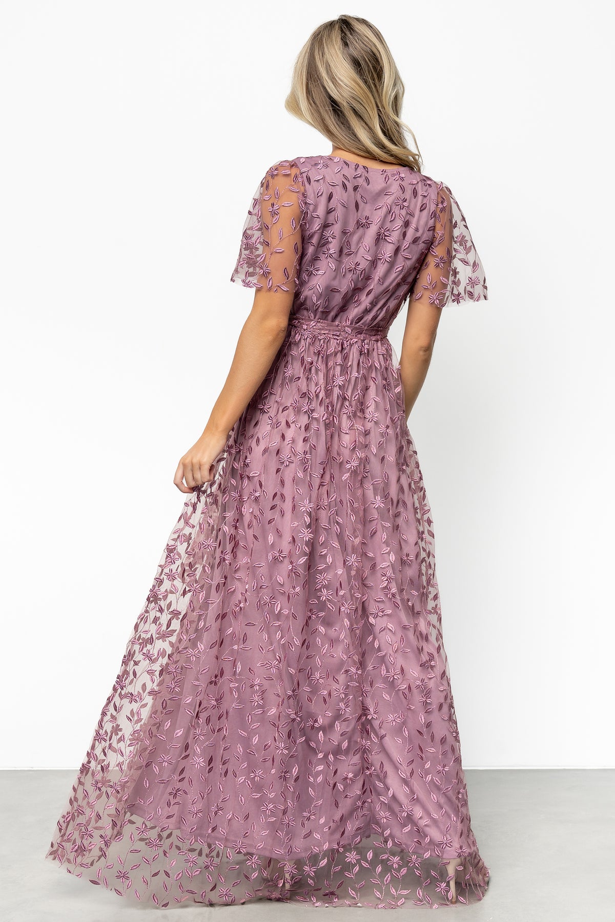 Close-up of vine-embossed organza fabric texture and floral embossing in soft lavender, showing structured weave and detail.