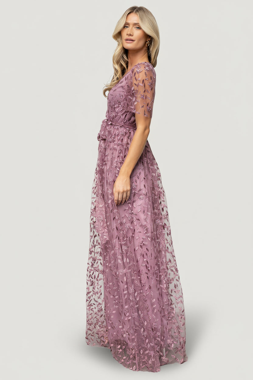Model wearing lavender Marseille maxi dress showing crossover surplice bodice, short unlined sleeves, and inverted lining seam.
