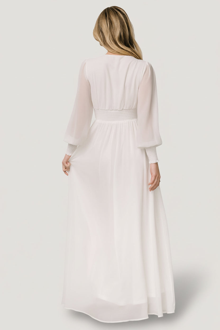 Studio shot of model in the Olivia Maxi Dress white highlighting silhouette, length, and the dress’s tailored yet forgiving fit suitable for maternity.