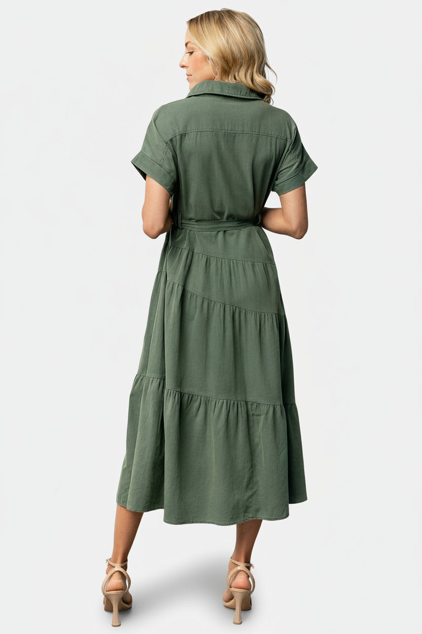 Detail shot of cuffed short sleeves and fabric texture of the Logan Button Up Dress in washed green, noting the cotton-poly blend with no stretch.