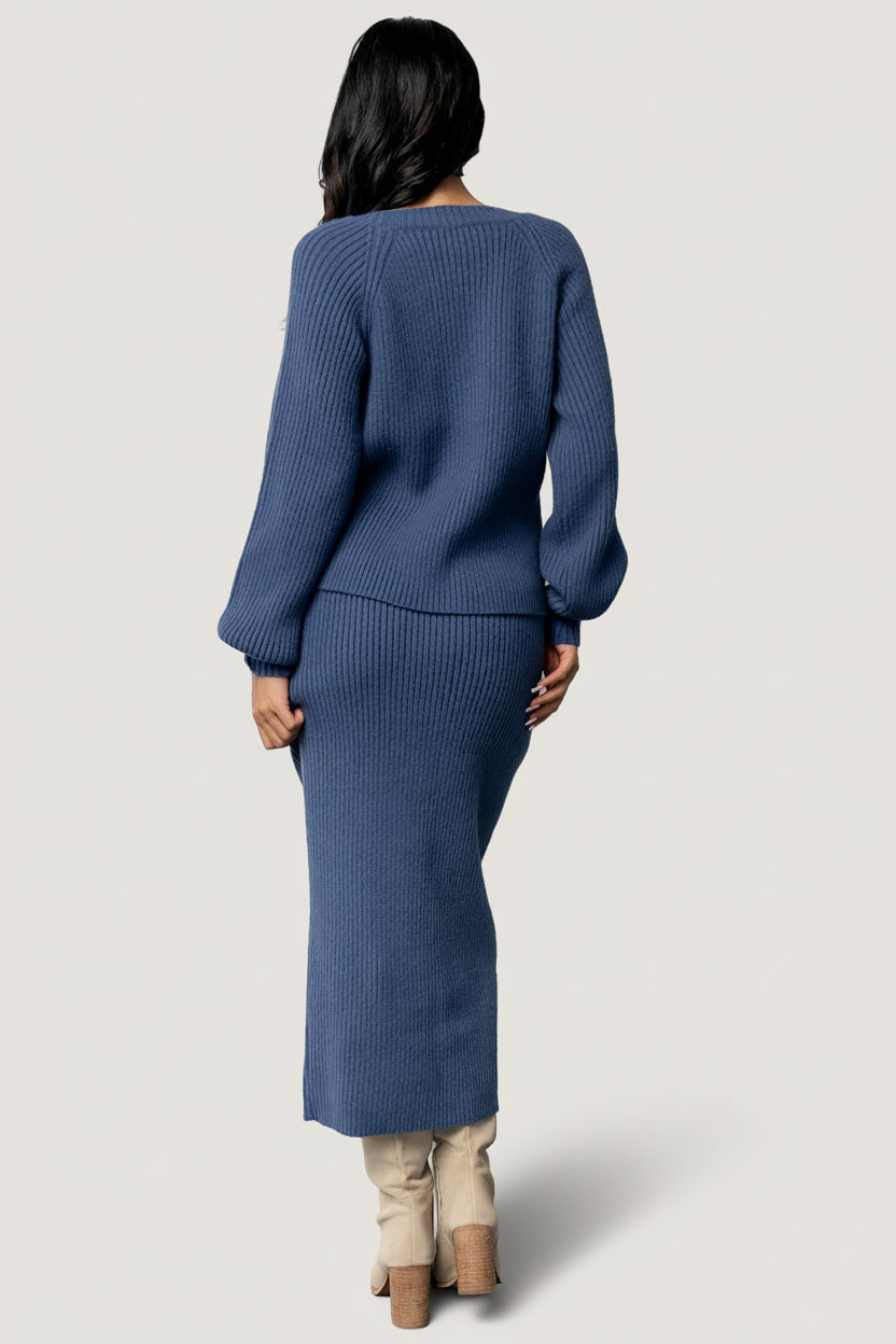 Flat-lay of the Blair rib knit cardigan in blue, displaying texture, button placement, and ribbed sleeve cuffs.