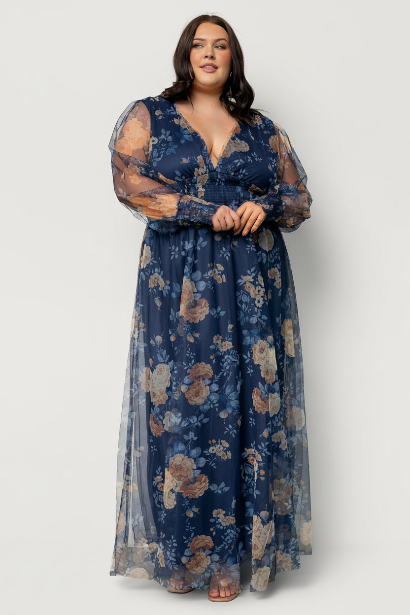 Back view of Layla tulle maxi dress showing fully lined skirt, sheer sleeves, delicate floral pattern and gentle floor-length drape.