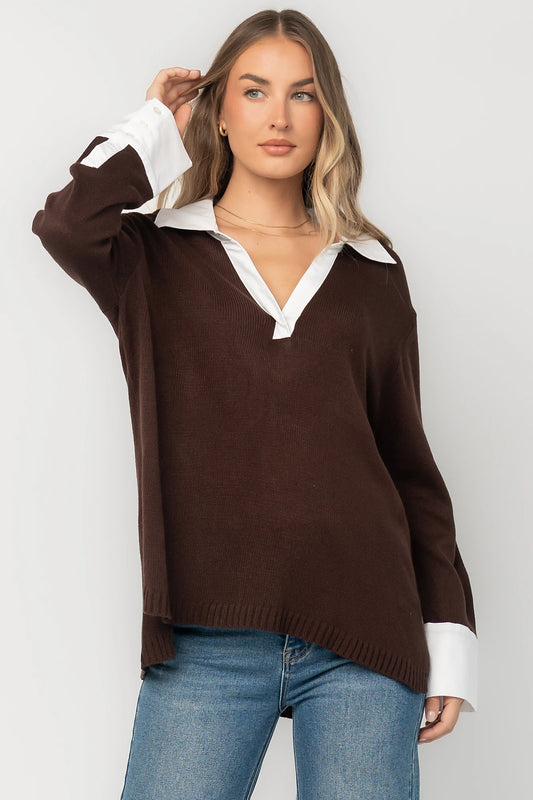 Chocolate sweater top with a contrast white collared neckline and cuffs, split V-neck, long sleeves, side hem slits, ribbed hem, and a relaxed fit.