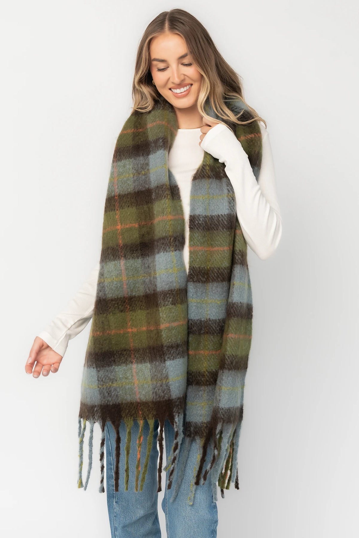 Maison Oversized Scarf with sage green, soft blue and neutral plaid, brushed texture, and fringe trim.