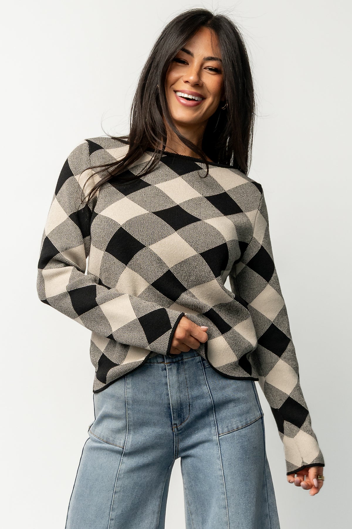 Three-quarter side view of the sweater highlighting diamond pattern and relaxed fit across the shoulder and sleeve with ribbed trim details.