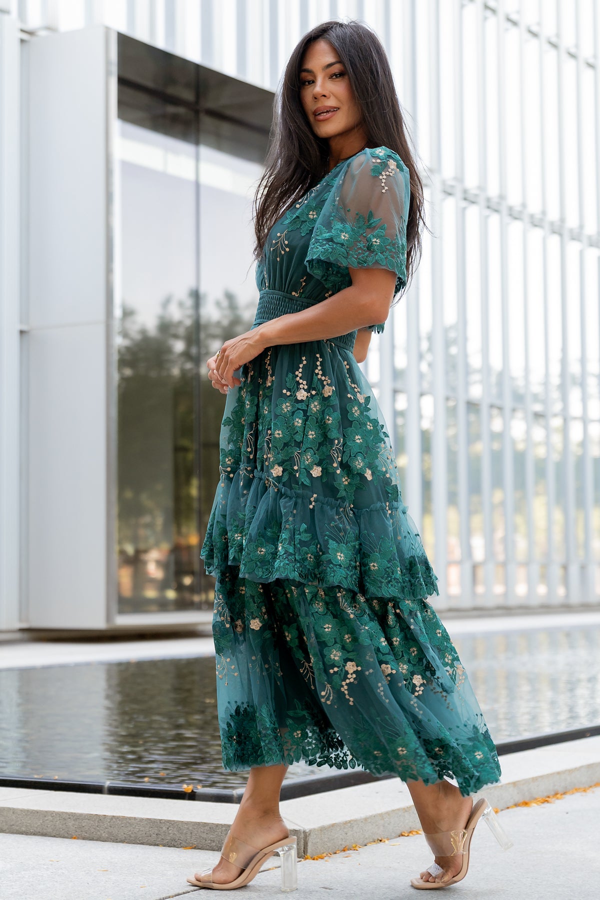Back view of the dress showing delicate embroidery across the upper back, layered tulle skirt and seam finish at the waist.