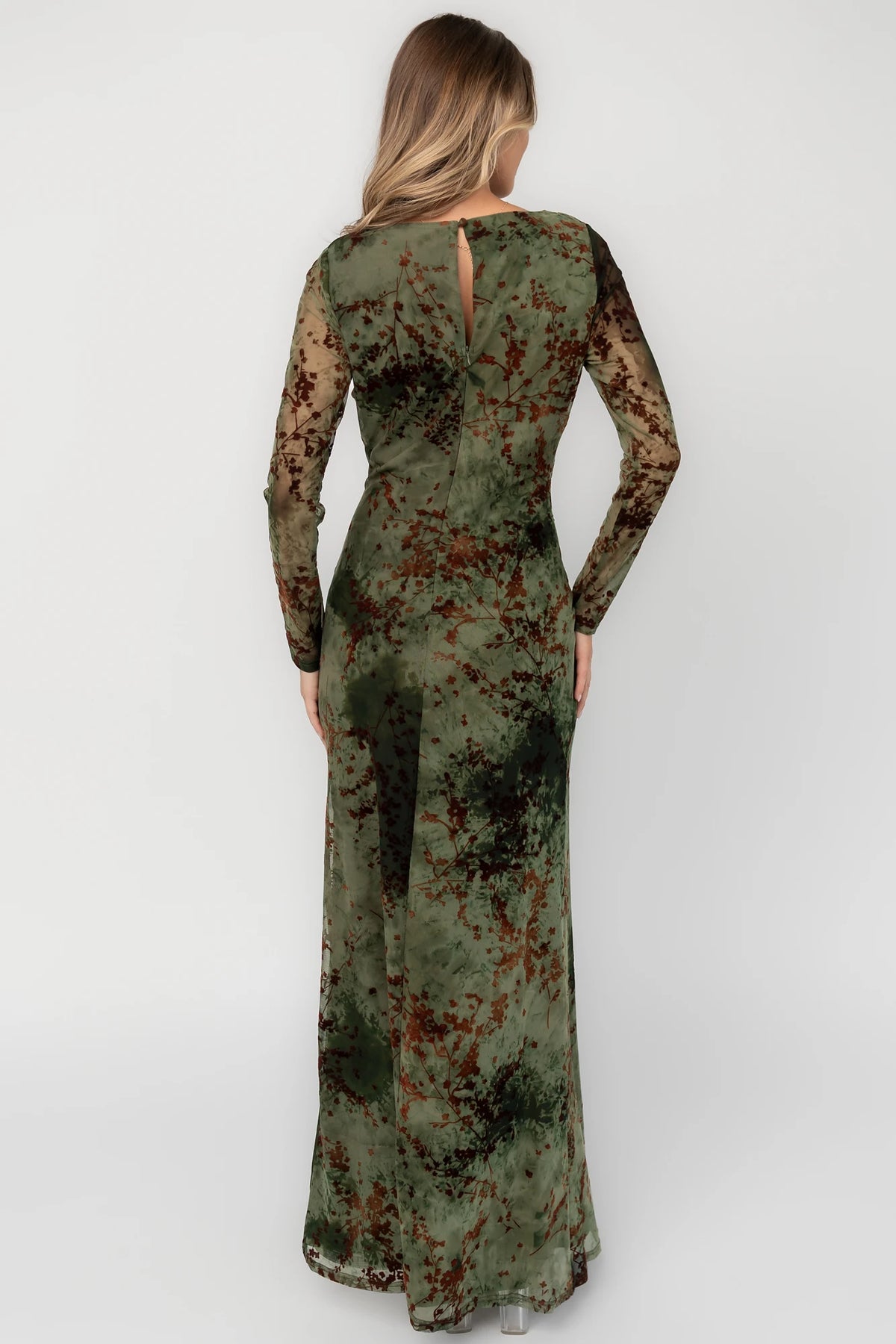 Green and rust floral mesh maxi dress with sheer long sleeves, boat neckline, and fitted silhouette.