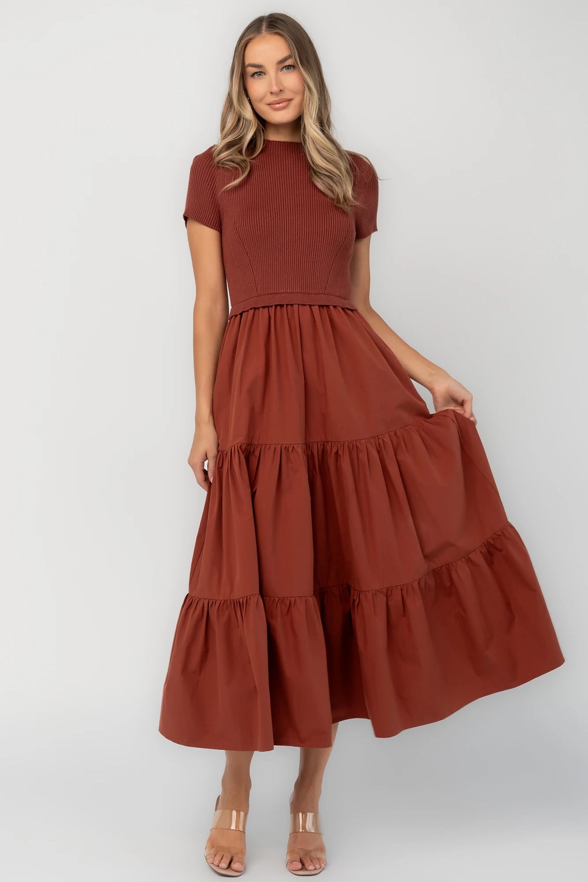 Midi dress with a ribbed knit bodice, round neckline, short sleeves, elastic waist, tiered woven skirt, and side pockets.