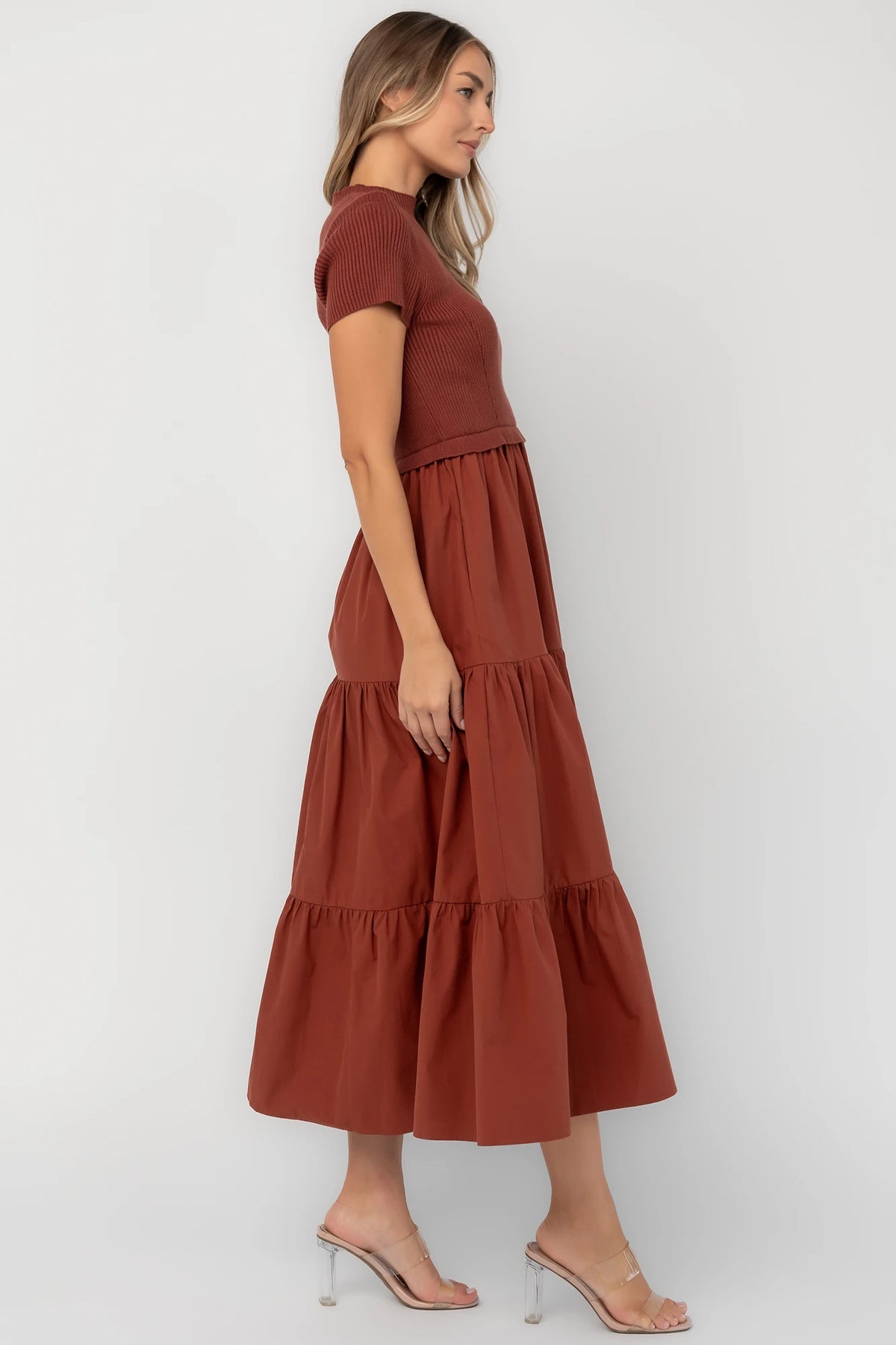 Midi dress with a ribbed knit bodice, round neckline, short sleeves, elastic waist, tiered woven skirt, and side pockets.