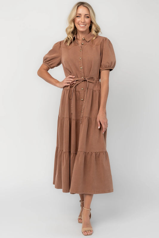 Dusty mocha midi dress with a collared neckline, gold-tone button-front closure, short puff sleeves, removable waist tie, and tiered skirt.