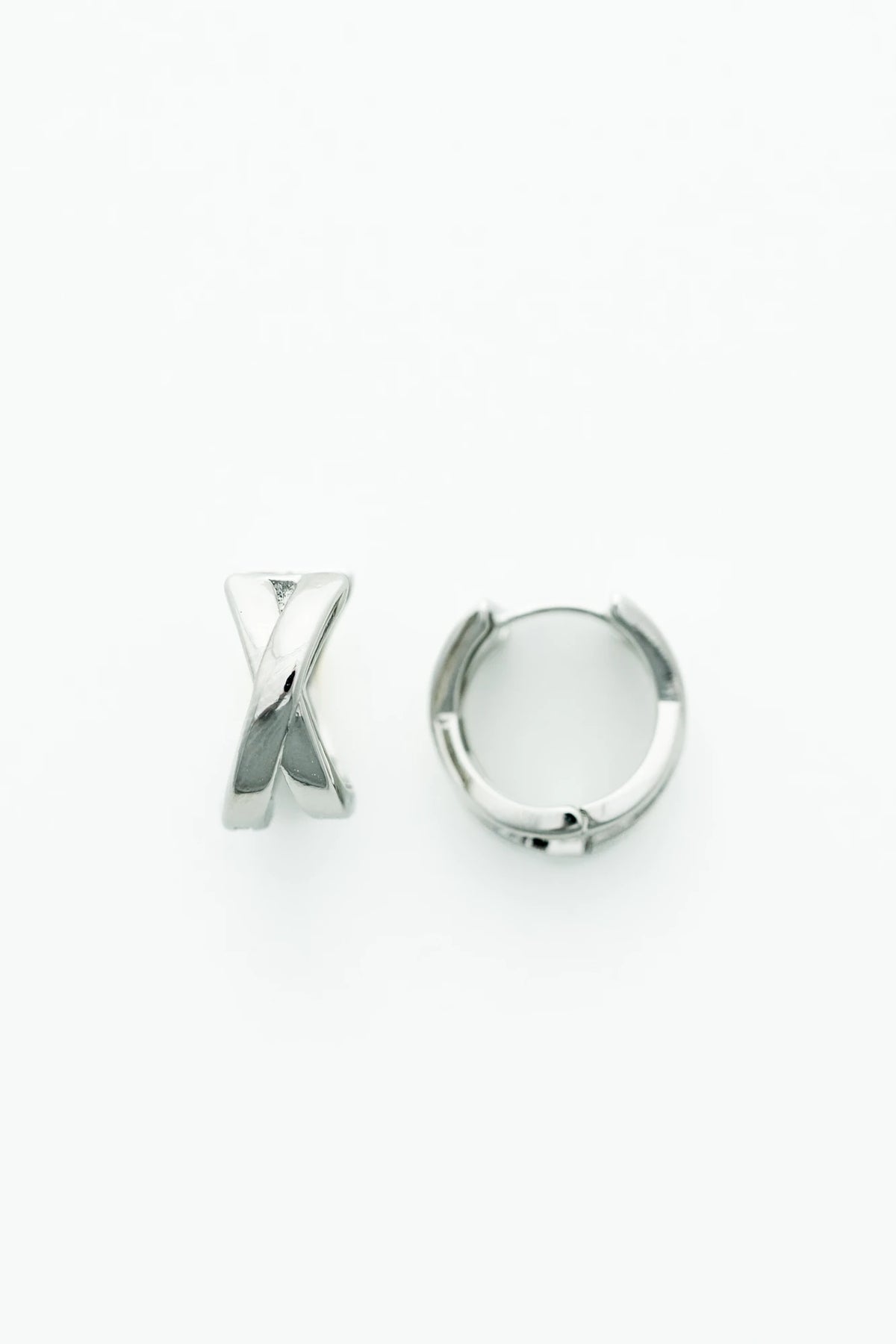 Silver-tone huggie earrings with a polished finish