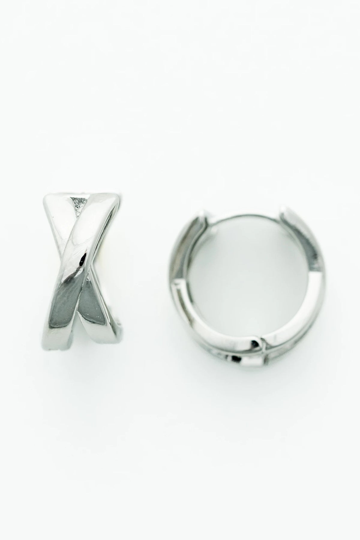 Silver-tone huggie earrings with a polished finish