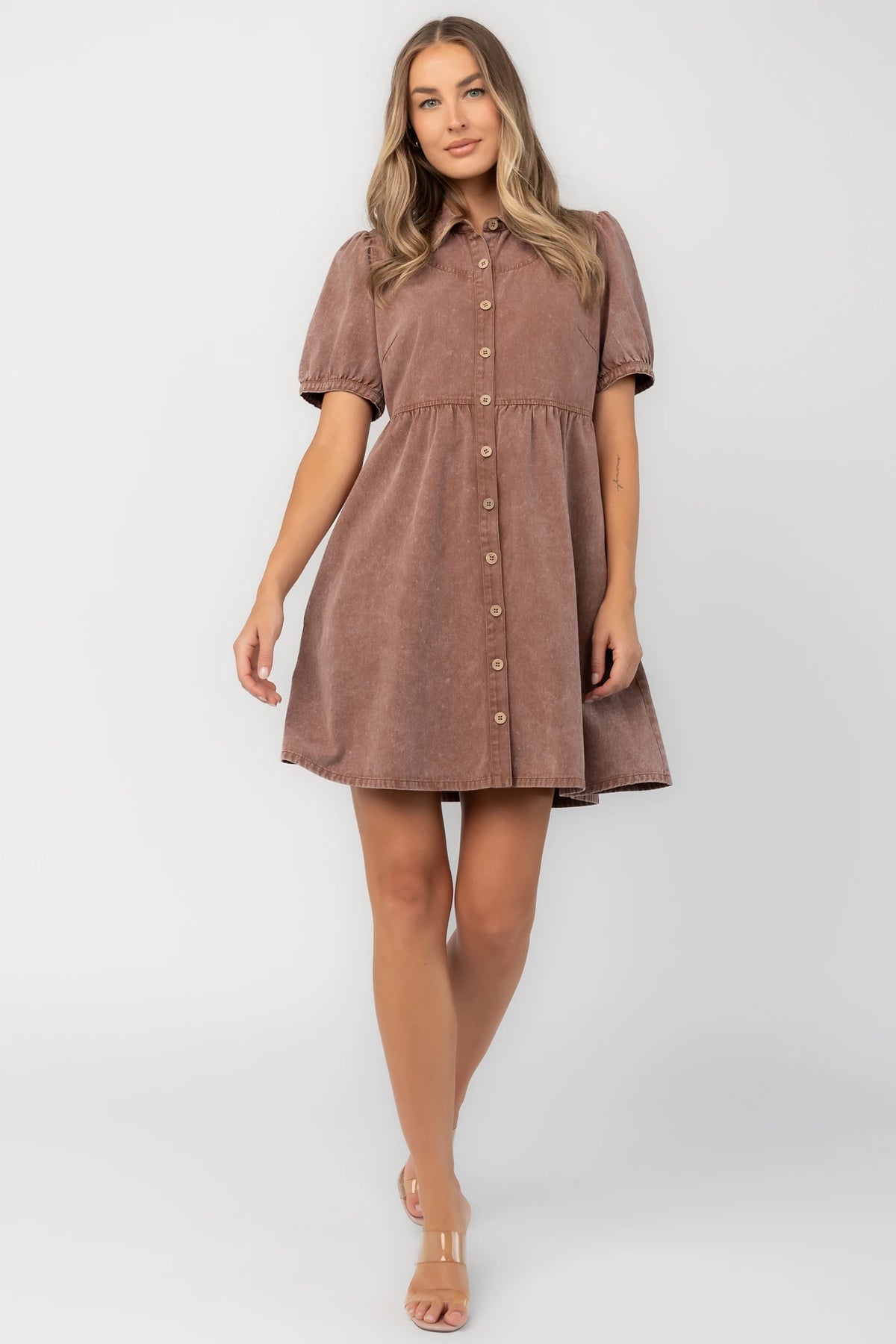 Dusty mocha mineral wash mini dress with a collared neckline, button-front closure, short puff sleeves, empire waist, and relaxed silhouette.