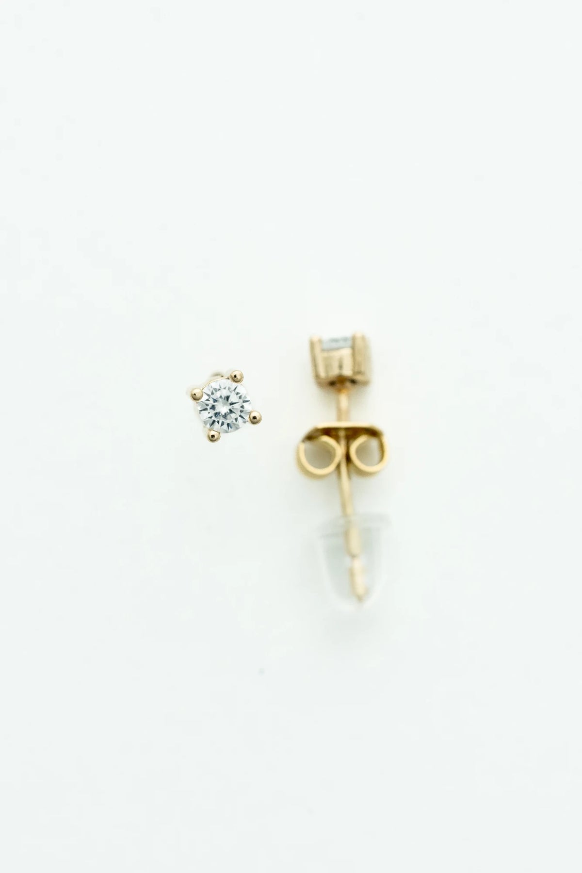 Round crystal stud earrings set in a gold-tone prong setting.