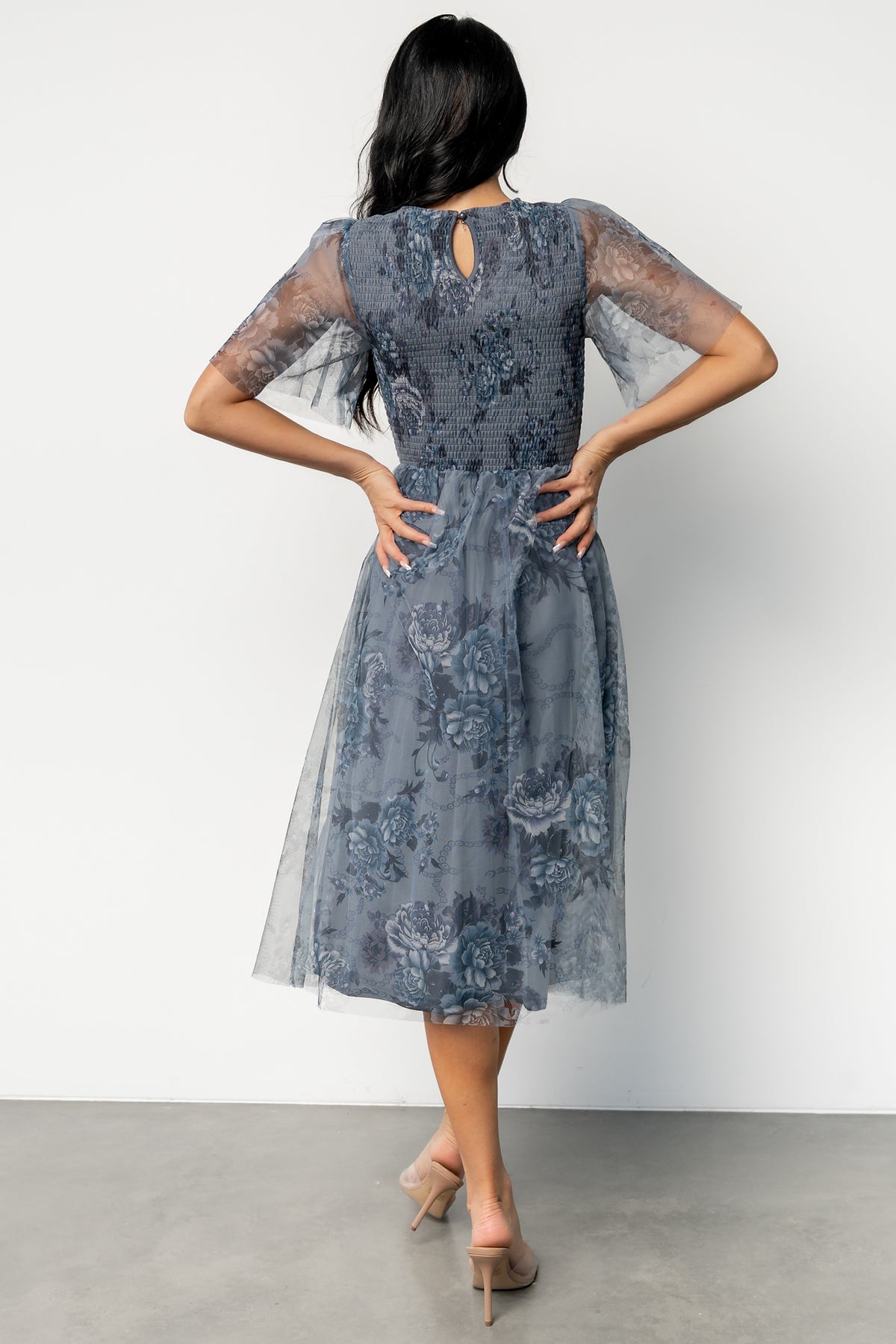 Back view of Josie Tulle Midi Dress showcasing keyhole closure, short sleeves, and the gentle drape of the lined midi skirt.