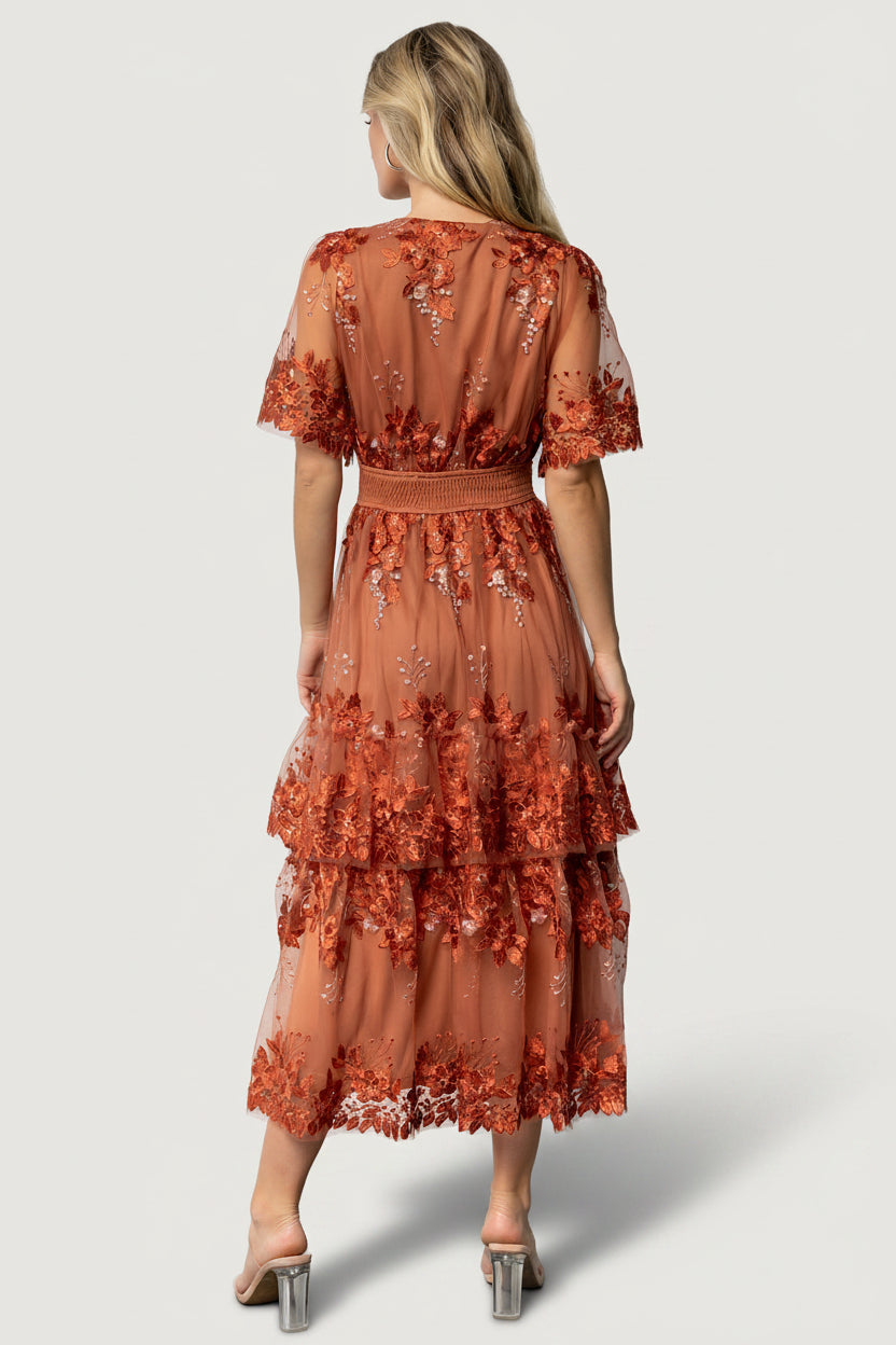 Detail shot of rose-gold and rust floral embroidery on tulle and the single ruffle tiered overlay for texture and dimension.