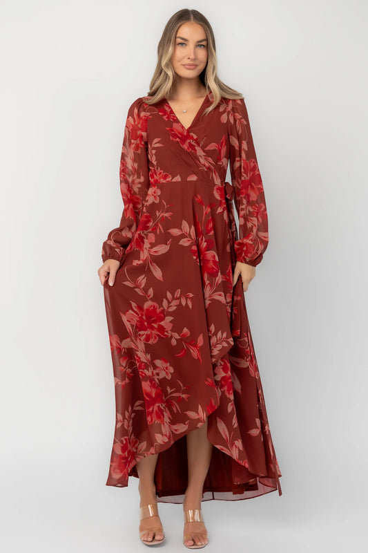 Rust multi floral chiffon maxi dress with a faux wrap neckline, long balloon sleeves, adjustable waist tie, and a high-low skirt.