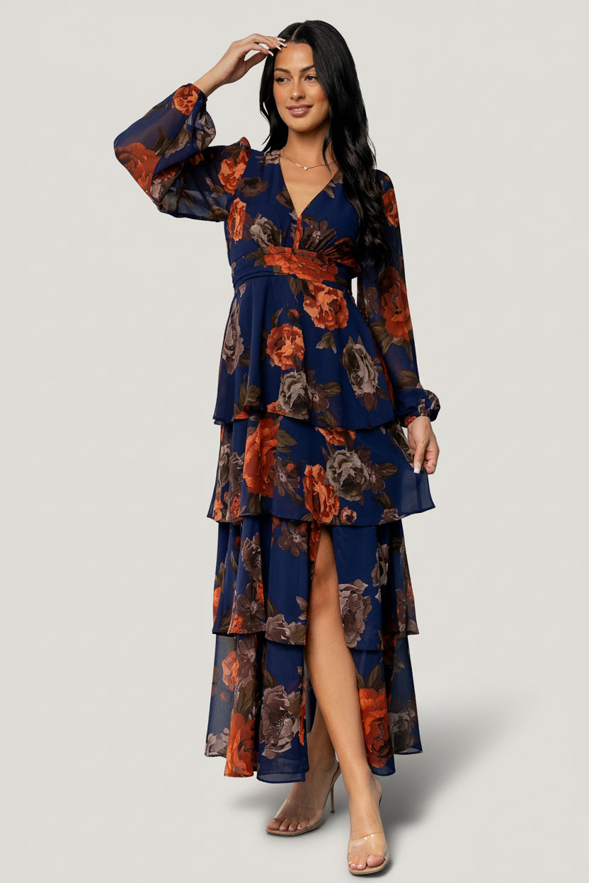 Front view of Mariella Tiered Maxi Dress in navy and rust floral chiffon, showing V-neckline, smocked back, and tiered ruffle skirt for occasion wear.
