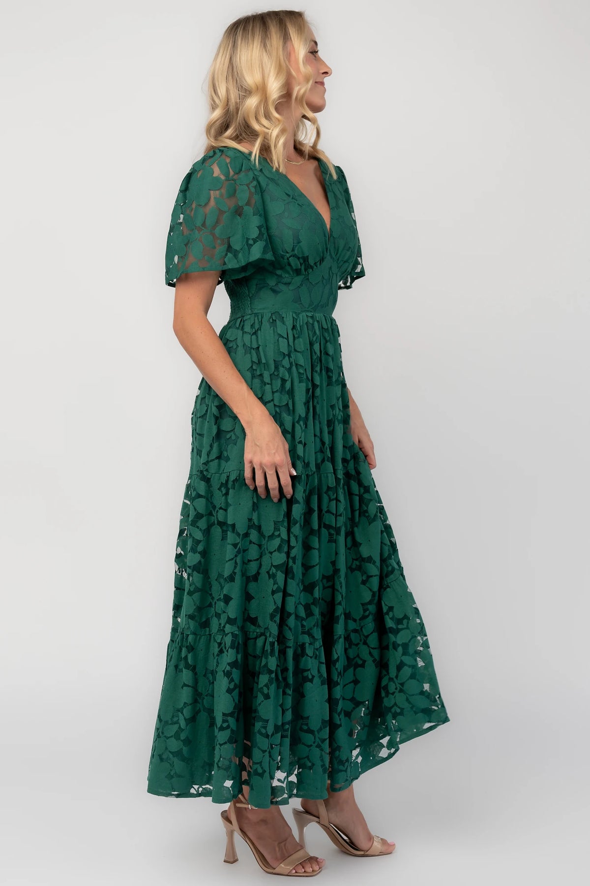 Floral lace midi dress with a deep V-neckline, short flutter sleeves, smocked back bodice, defined waistband, and tiered skirt.
