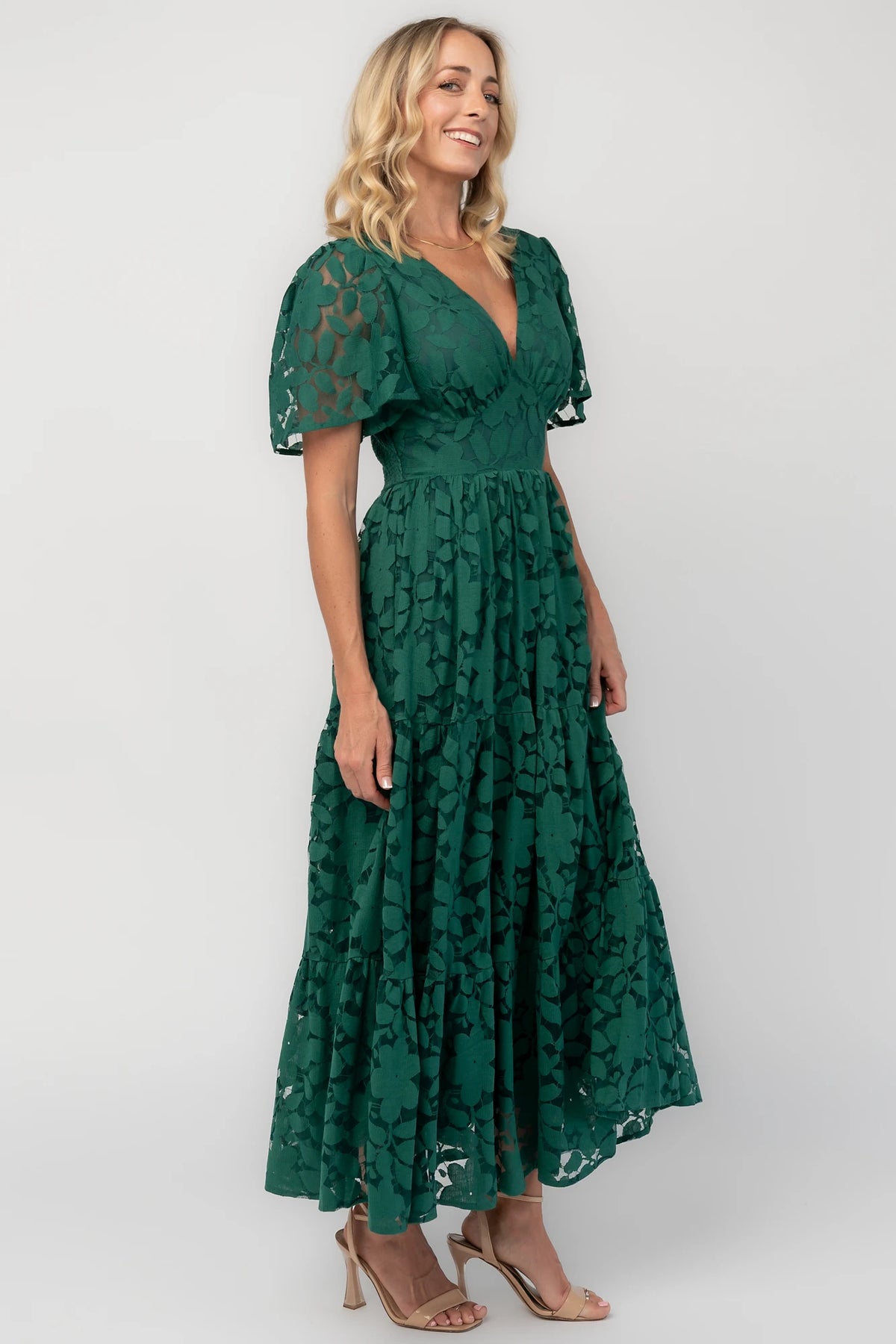 Floral lace midi dress with a deep V-neckline, short flutter sleeves, smocked back bodice, defined waistband, and tiered skirt.