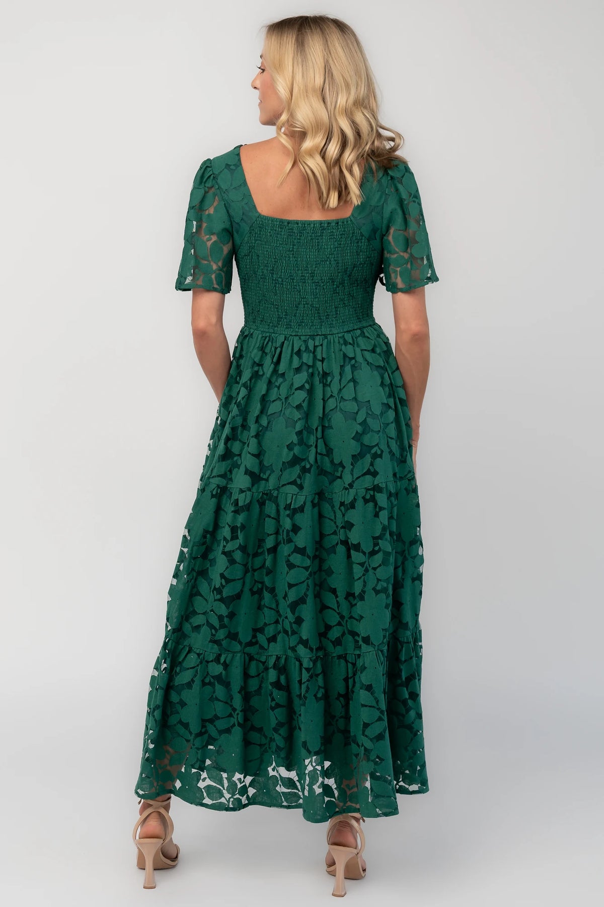 Floral lace midi dress with a deep V-neckline, short flutter sleeves, smocked back bodice, defined waistband, and tiered skirt.