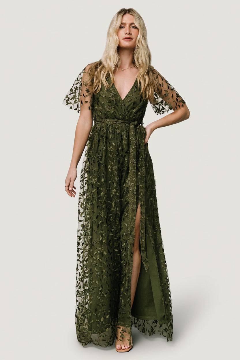 Front view of olive Marseille maxi dress showing vine-embossed organza, surplice neckline, elastic waist, and left-side slit for movement.