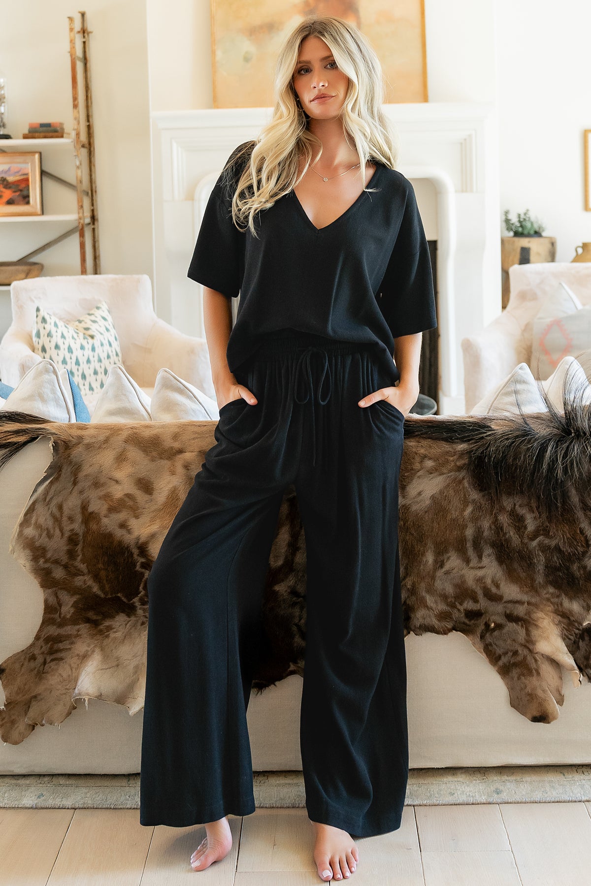 Front view of model wearing Timbre Matching Set in black, V-neck top with side split hem and wide-leg pants.