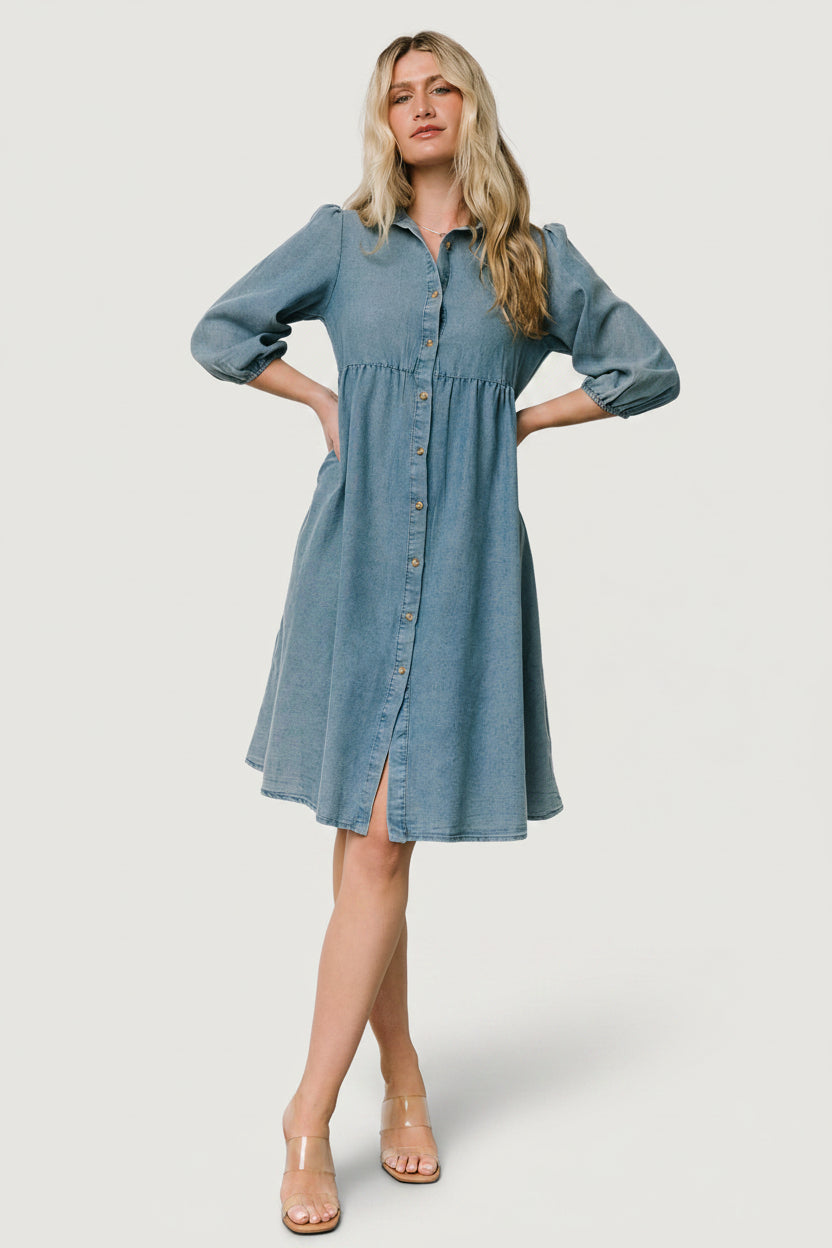 Front view of Sari Chambray Babydoll Dress on a model, showing the collar, full button-front, side pockets, and tiered skirt.