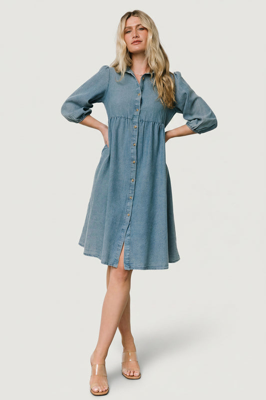Front view of Sari Chambray Babydoll Dress on a model, showing the collar, full button-front, side pockets, and tiered skirt.