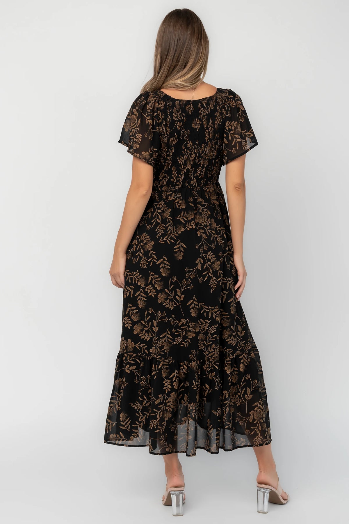 Black and gold chiffon maxi dress with a V-neckline, flutter sleeves, smocked bodice, empire waist, tiered skirt, and side pockets.