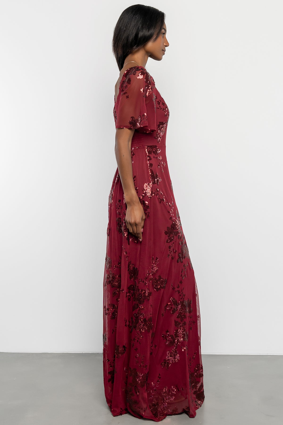 Close-up of floral sequin embellishment and mesh overlay on the Karina sequin maxi dress in wine, highlighting texture and sparkle.
