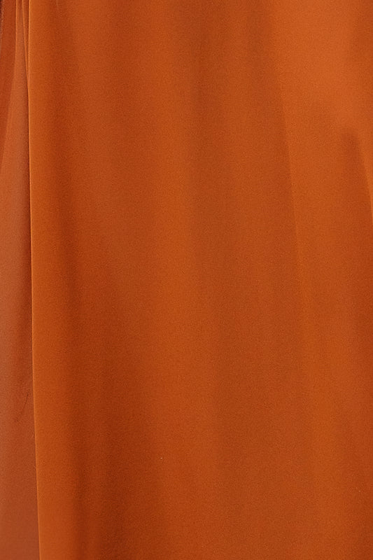 Flat lay of a 3 x 4 inch Spice chiffon fabric swatch for the Victoria dress, showing true color and slight sheerness.