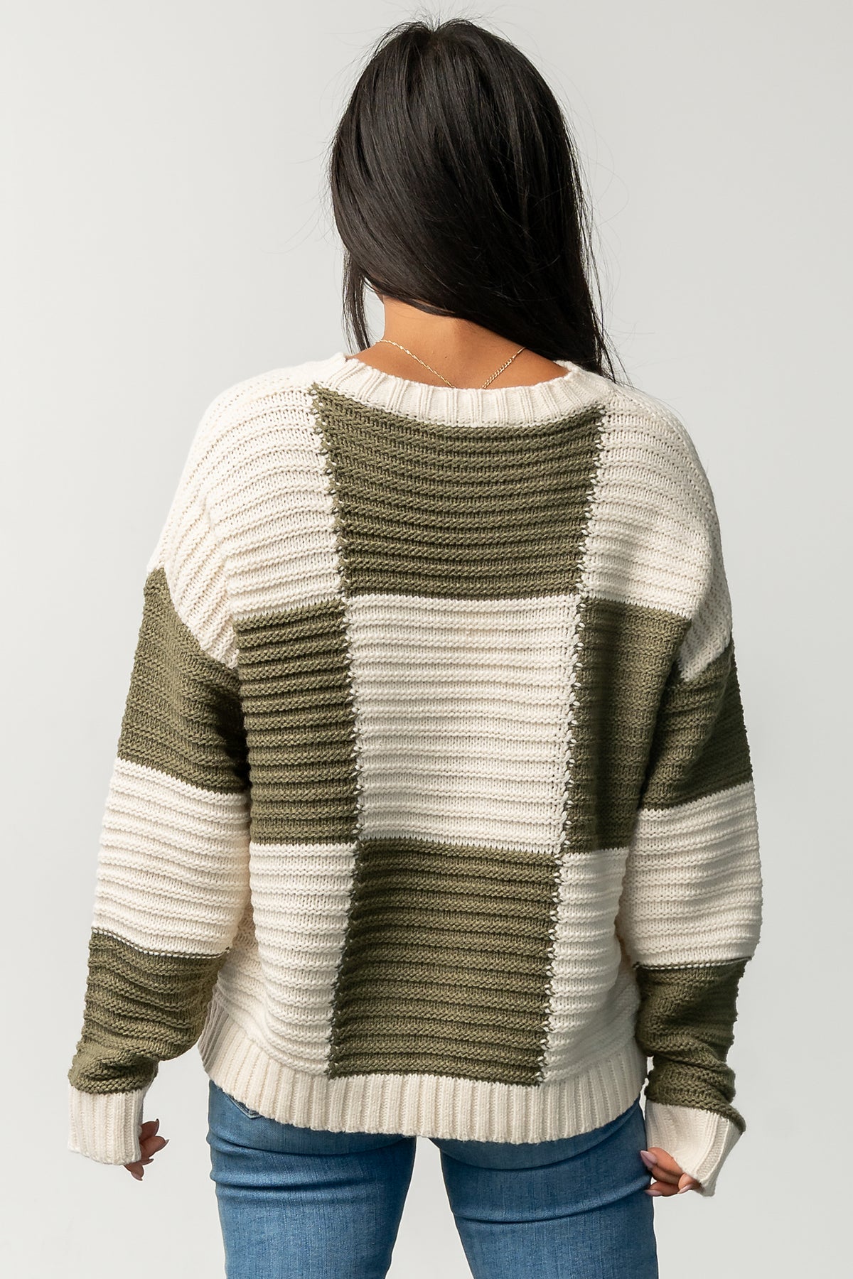 Back and side view of Jayda checkered sweater showing relaxed silhouette, drop shoulder, and how the hem and cuffs sit while worn.