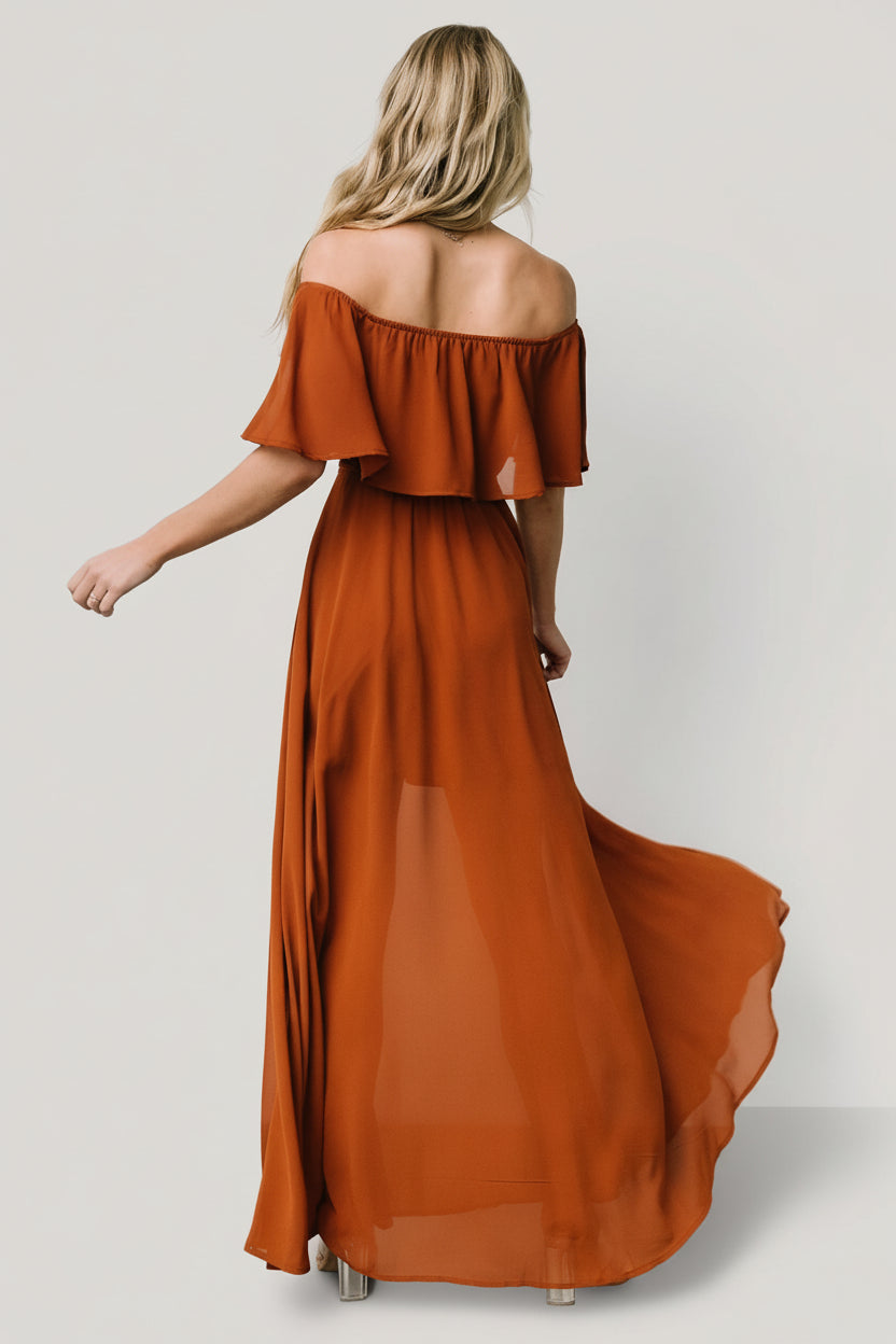 Side view of the Spice off-shoulder maxi dress highlighting the self-tie tassel belt and drape of the skirt.