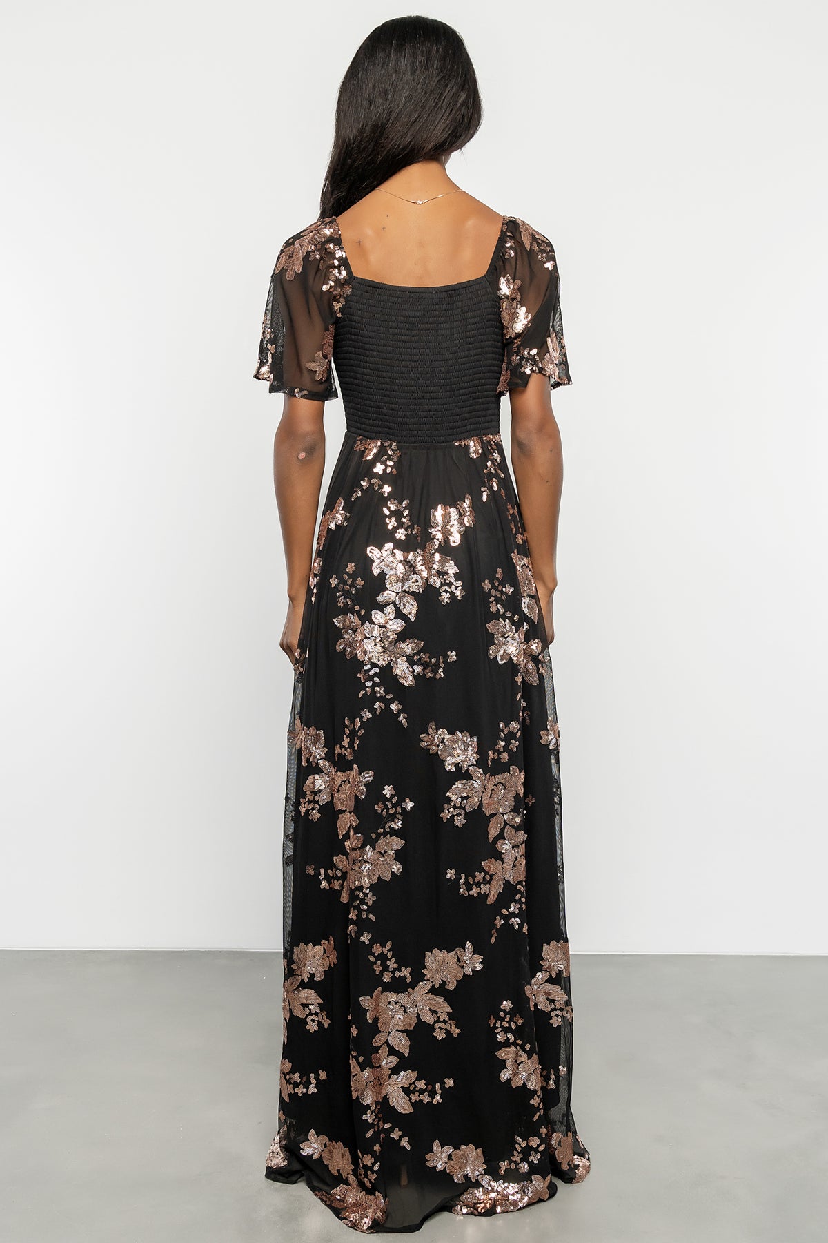 Back view showing smocked back bodice, elastic at the waist, and the gentle drape of the fully lined skirt.