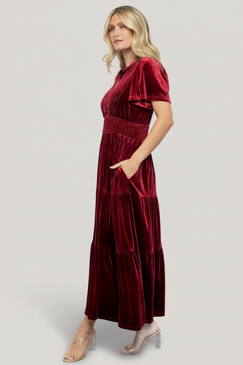 Close-up of Maida dress fabric showing cranberry velvet texture, delicate embroidery on front bodice and slight stretch in the material.