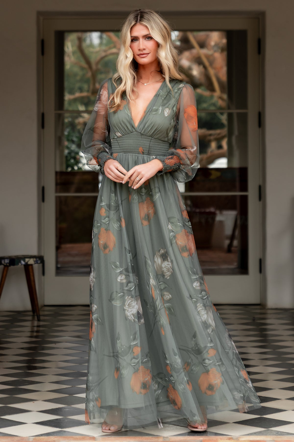 Front view of Layla Tulle Maxi Dress in dusty olive floral, showing deep V-neckline, smocked waist and flowing tulle skirt, model standing.