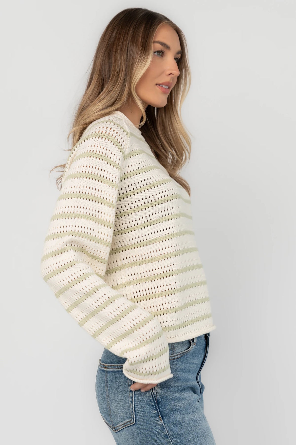 Cream and sage striped open-knit sweater with a round neckline, long sleeves, rolled trim, and a relaxed fit.