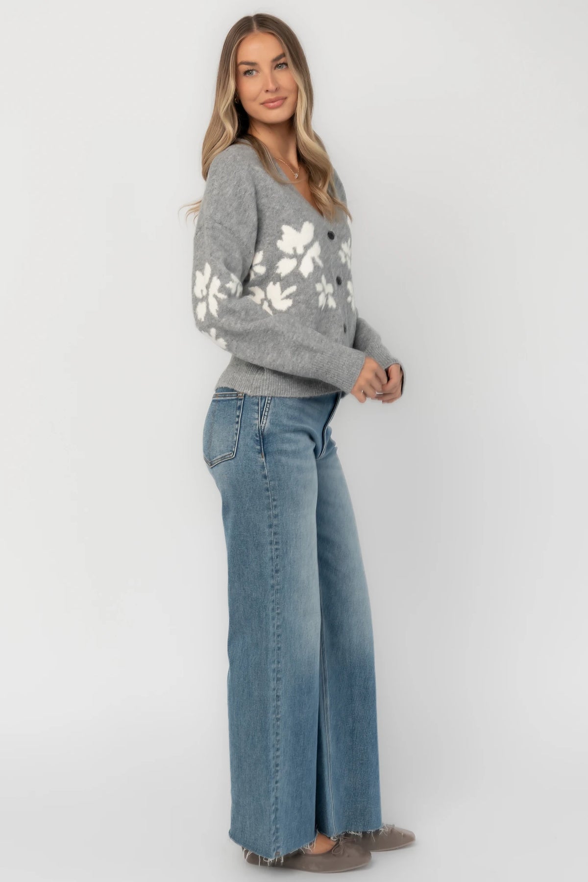 Gray floral knit cardigan with a V-neckline, button-front closure, long sleeves, ribbed trim, and a relaxed silhouette.