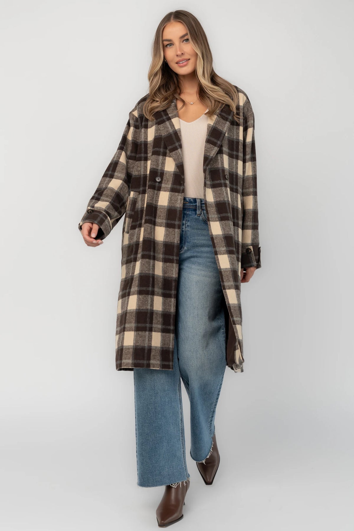 Brown plaid double-breasted longline coat with a collared lapel neckline, side pockets, back slit, and relaxed tailored fit.