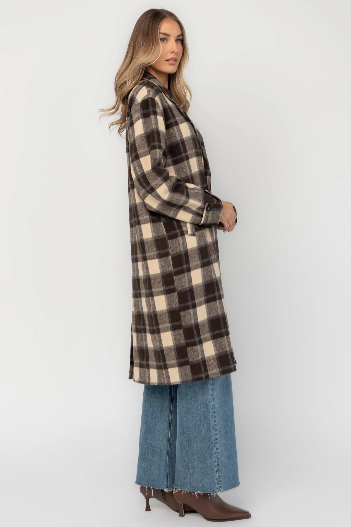 Brown plaid double-breasted longline coat with a collared lapel neckline, side pockets, back slit, and relaxed tailored fit.