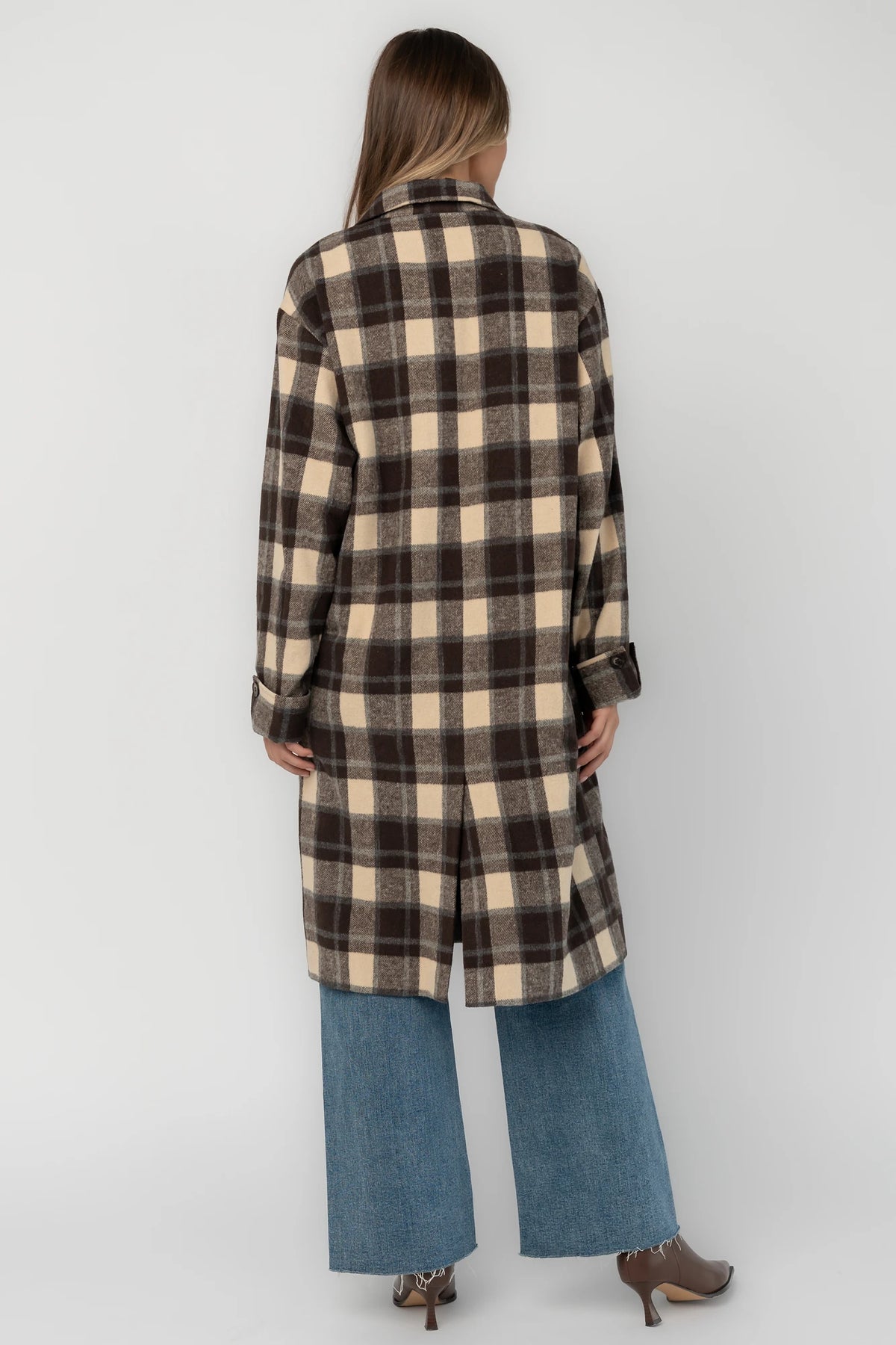 Brown plaid double-breasted longline coat with a collared lapel neckline, side pockets, back slit, and relaxed tailored fit.